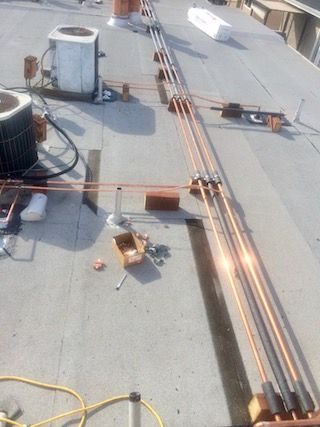 Condo repipe runs across a roof